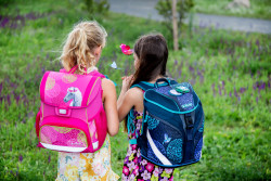 Schoolbags, 2 girls on meadow