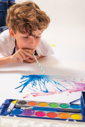 Boy crating a "blow monster"