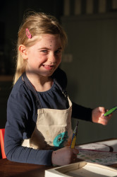 Girl with painting apron and g...